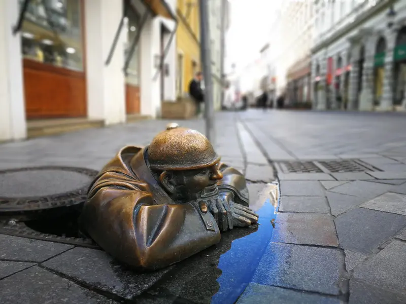 Čumil, the bronze “Man at Work” statue peeking out of a manhole in Bratislava’s Old Town