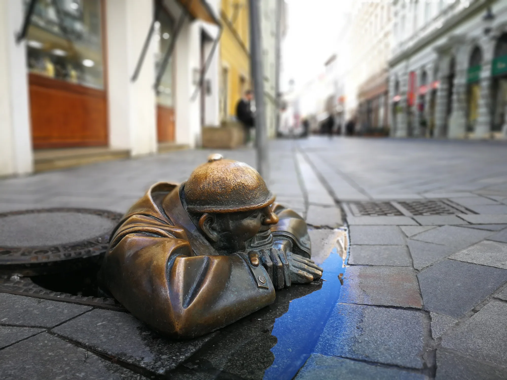 Čumil, the bronze “Man at Work” statue peeking out of a manhole in Bratislava’s Old Town