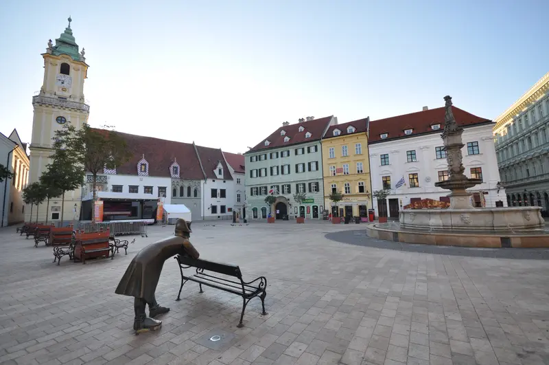 The bronze statue of a Napoleonic soldier leaning on a bench on Bratislava’s Main Square
