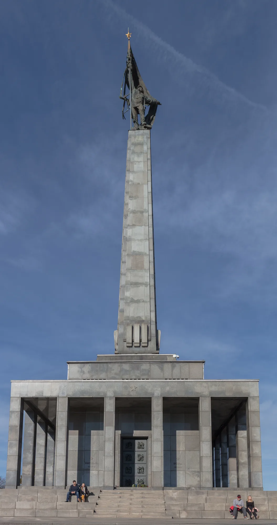 The Slavín war memorial in Bratislava — a tall stone pylon topped by a bronze soldier